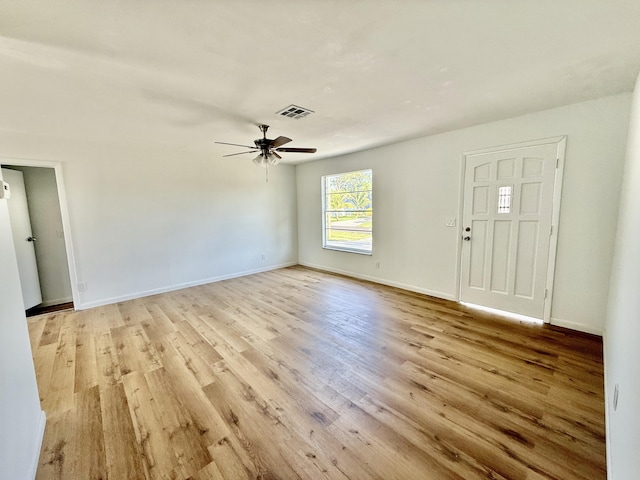 711 NW Riverside Dr, Port Saint Lucie, FL 34983 - unfurnished living room featuring light wood finished floors, ceiling fan, and baseboards
