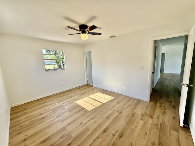 711 NW Riverside Dr, Port Saint Lucie, FL 34983 - spare room featuring light wood finished floors, a ceiling fan, and baseboards