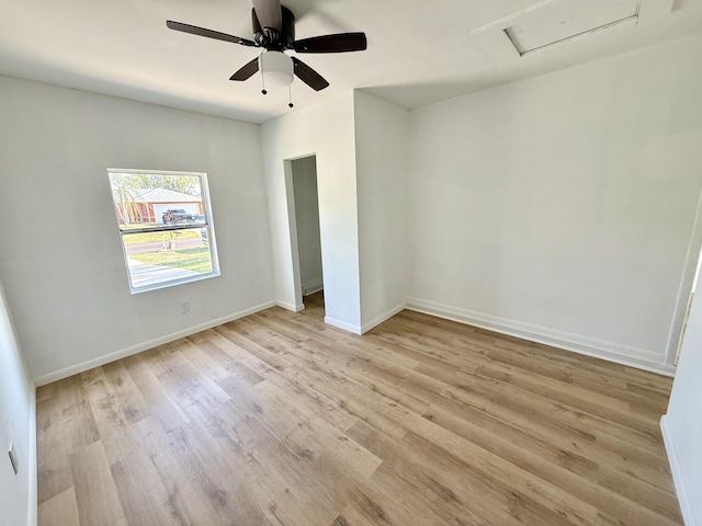 711 NW Riverside Dr, Port Saint Lucie, FL 34983 - unfurnished bedroom featuring attic access, light wood-type flooring, baseboards, and a ceiling fan