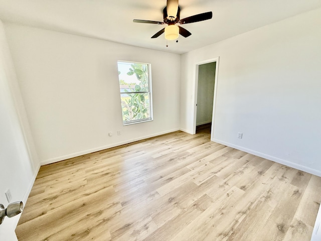 711 NW Riverside Dr, Port Saint Lucie, FL 34983 - unfurnished room with light wood-style floors, a ceiling fan, and baseboards