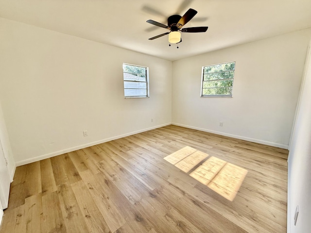 711 NW Riverside Dr, Port Saint Lucie, FL 34983 - unfurnished room with healthy amount of natural light, light wood-type flooring, a ceiling fan, and baseboards