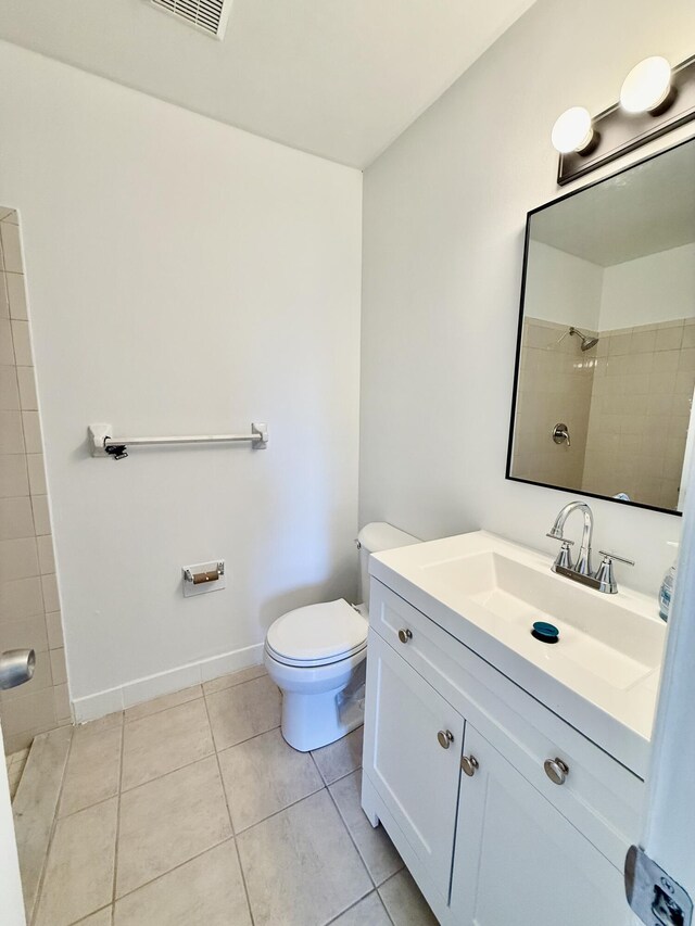 711 NW Riverside Dr, Port Saint Lucie, FL 34983 - full bath with toilet, tile patterned flooring, vanity, a shower, and baseboards