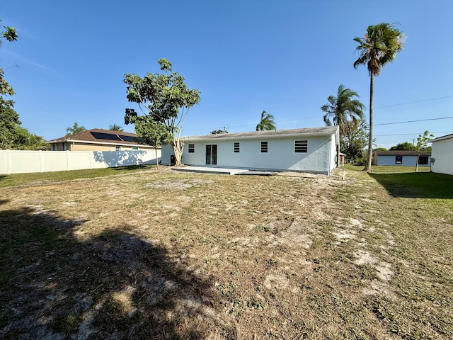 711 NW Riverside Dr, Port Saint Lucie, FL 34983 - rear view of house featuring a patio area