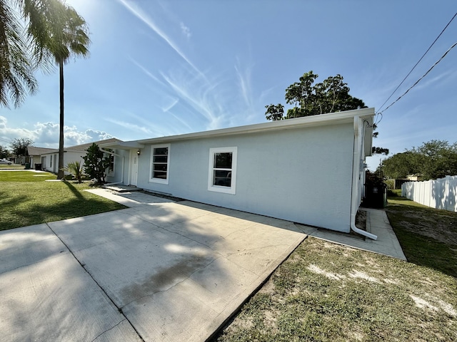 711 NW Riverside Dr, Port Saint Lucie, FL 34983 - back of property featuring a patio area and stucco siding