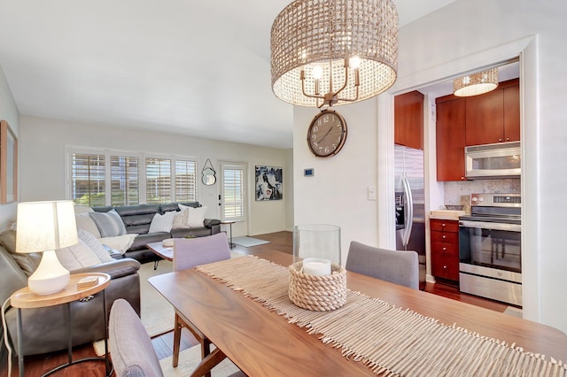 426 NE 7th Ave Unit 1F, Delray Beach, FL 33483 - dining area with wood finished floors and a chandelier