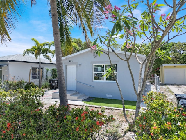423 N F St, Lake Worth Beach, FL 33460 - view of front of home featuring stucco siding and a garage