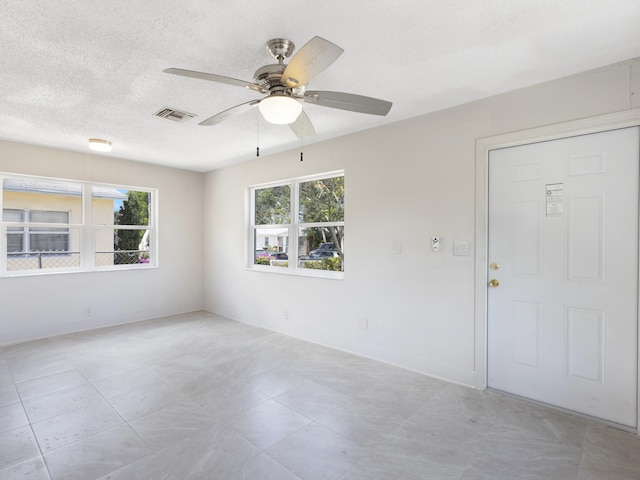 423 N F St, Lake Worth Beach, FL 33460 - spare room featuring a ceiling fan, a textured ceiling, and baseboards