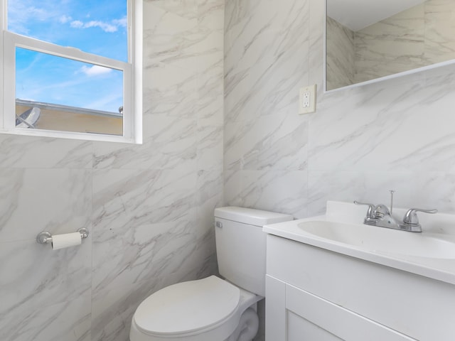 423 N F St, Lake Worth Beach, FL 33460 - bathroom featuring tile walls, vanity, and toilet