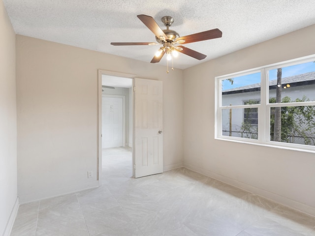 423 N F St, Lake Worth Beach, FL 33460 - spare room with baseboards, ceiling fan, and a textured ceiling