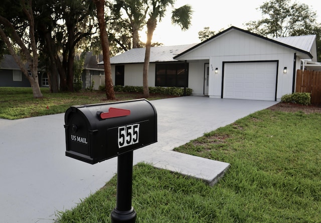 555 Benedictine Ter, Sebastian, FL 32958 - ranch-style house featuring a garage, driveway, a front lawn, and metal roof