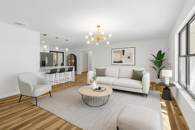 555 Benedictine Ter, Sebastian, FL 32958 - living area with plenty of natural light, light wood-type flooring, a chandelier, and baseboards