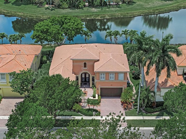 1885 Via Bellezza, Wellington, FL 33411 - mediterranean / spanish house with a water view, a tiled roof, decorative driveway, and a garage