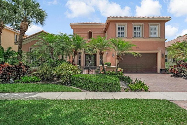 1885 Via Bellezza, Wellington, FL 33411 - mediterranean / spanish home with stucco siding, decorative driveway, an attached garage, and a tiled roof