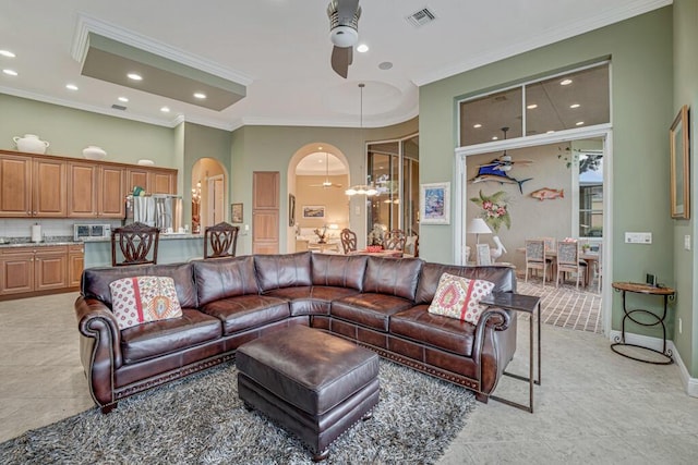 1885 Via Bellezza, Wellington, FL 33411 - living room featuring a ceiling fan, ornamental molding, arched walkways, light tile patterned floors, and recessed lighting