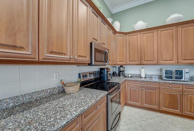 1885 Via Bellezza, Wellington, FL 33411 - kitchen featuring stainless steel appliances, ornamental molding, tasteful backsplash, dark stone counters, and light tile patterned floors