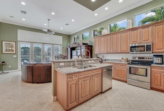 1885 Via Bellezza, Wellington, FL 33411 - kitchen featuring stainless steel appliances, a sink, light tile patterned floors, recessed lighting, and ornamental molding