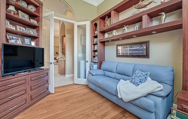 1885 Via Bellezza, Wellington, FL 33411 - living room featuring ornamental molding, arched walkways, and light wood finished floors