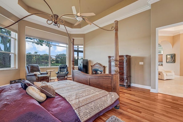 1885 Via Bellezza, Wellington, FL 33411 - bedroom with ornamental molding, light wood-type flooring, arched walkways, baseboards, and a ceiling fan