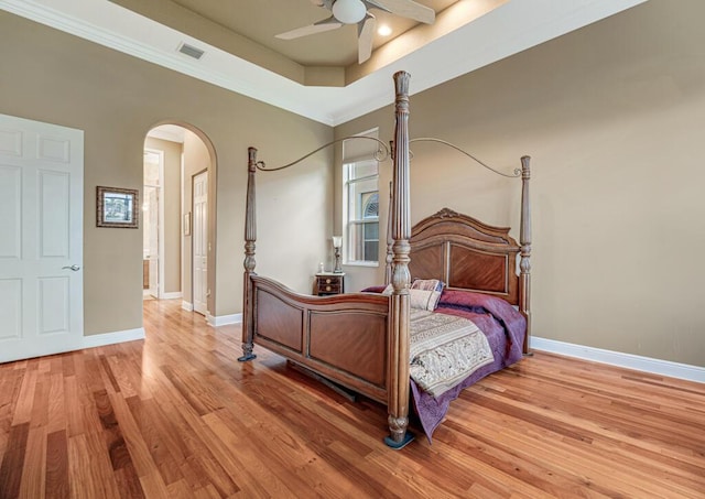 1885 Via Bellezza, Wellington, FL 33411 - bedroom featuring arched walkways, light wood finished floors, baseboards, and ornamental molding