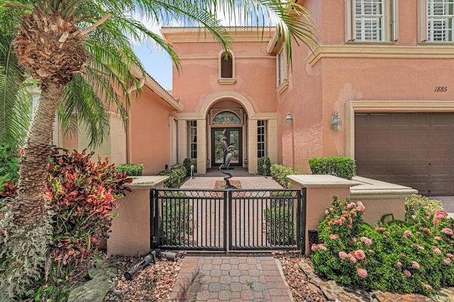 1885 Via Bellezza, Wellington, FL 33411 - property entrance featuring stucco siding, a gate, and a garage