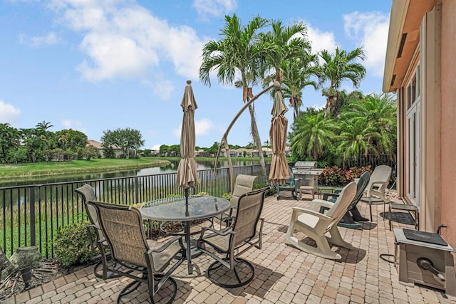 1885 Via Bellezza, Wellington, FL 33411 - fenced backyard with outdoor dining area, a water view, and a patio