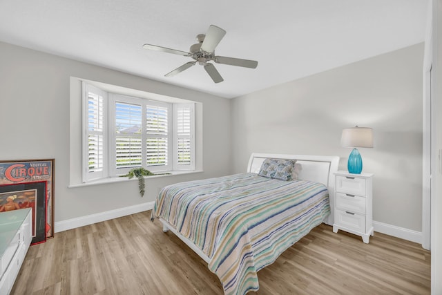 6304 SE Ames Way, Hobe Sound, FL 33455 - bedroom with baseboards, light wood-style floors, and a ceiling fan