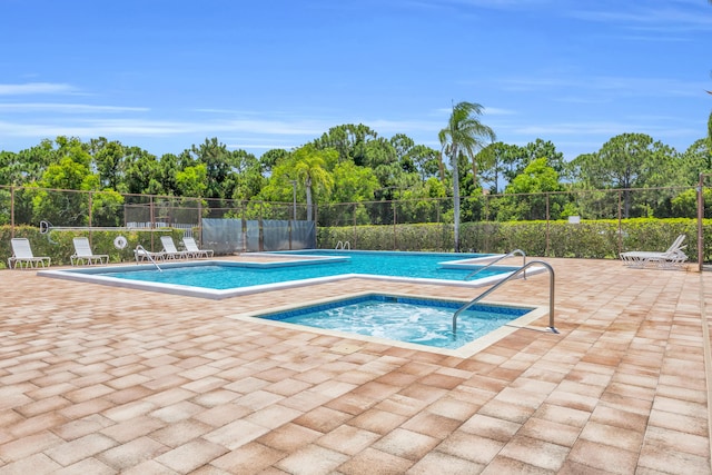 6304 SE Ames Way, Hobe Sound, FL 33455 - community pool featuring a hot tub, a patio, and view of wooded area