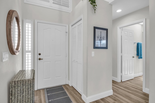 6304 SE Ames Way, Hobe Sound, FL 33455 - foyer entrance featuring light wood finished floors, baseboards, and plenty of natural light