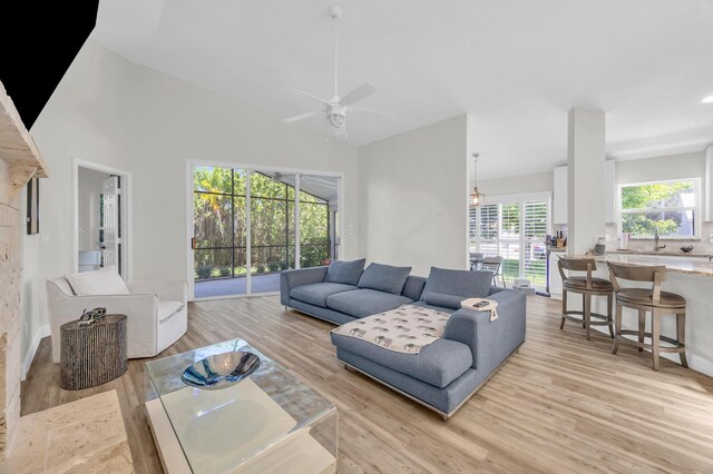 6304 SE Ames Way, Hobe Sound, FL 33455 - living room with light wood finished floors, a ceiling fan, and high vaulted ceiling