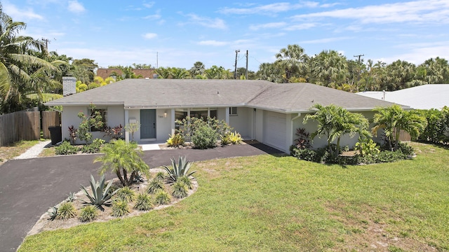 744 Eastwind Dr, North Palm Beach, FL 33408 - single story home with driveway, an attached garage, a chimney, and stucco siding