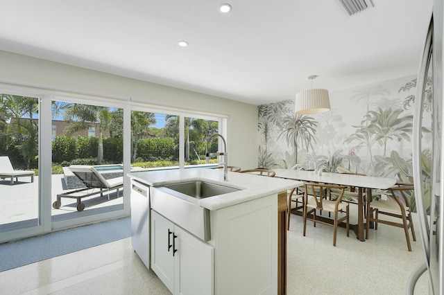 744 Eastwind Dr, North Palm Beach, FL 33408 - kitchen featuring wallpapered walls, plenty of natural light, stainless steel dishwasher, recessed lighting, and hanging light fixtures