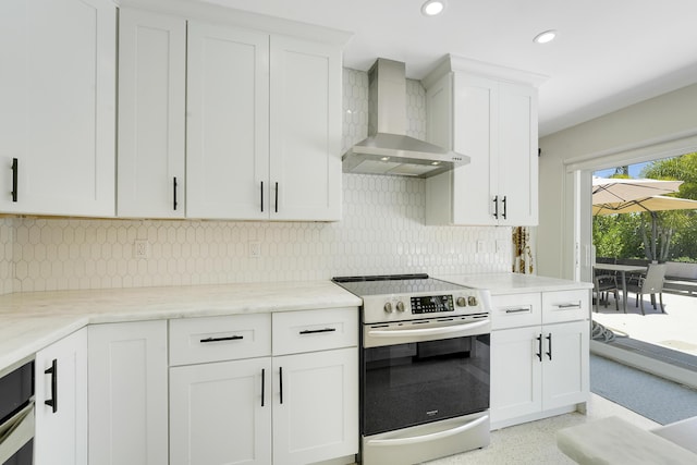 744 Eastwind Dr, North Palm Beach, FL 33408 - kitchen featuring stainless steel electric range oven, wall chimney exhaust hood, white cabinets, recessed lighting, and tasteful backsplash