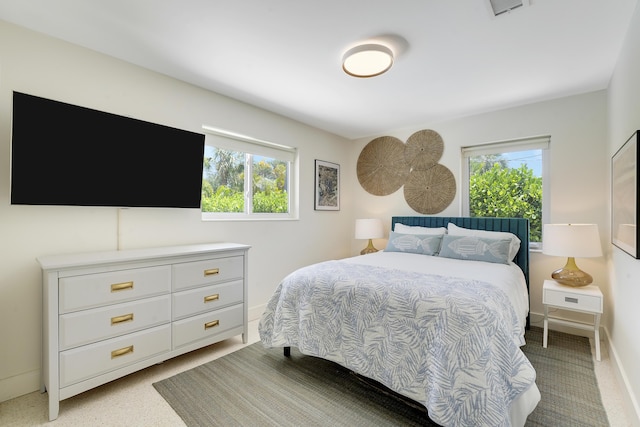 744 Eastwind Dr, North Palm Beach, FL 33408 - bedroom with multiple windows and baseboards