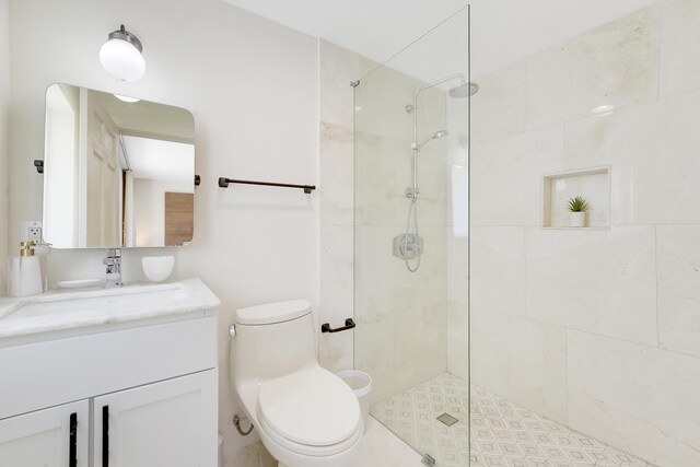 744 Eastwind Dr, North Palm Beach, FL 33408 - bathroom with vanity, toilet, and a tile shower