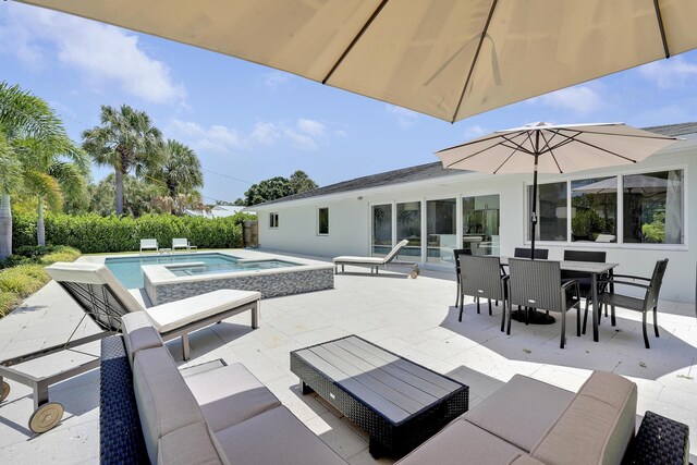 744 Eastwind Dr, North Palm Beach, FL 33408 - view of patio featuring outdoor dining space and a pool with connected hot tub