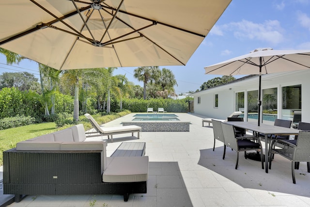 744 Eastwind Dr, North Palm Beach, FL 33408 - view of patio featuring an in-ground hot tub, outdoor dining area, and an outdoor hangout area