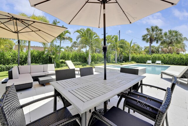 744 Eastwind Dr, North Palm Beach, FL 33408 - view of patio / terrace with an outdoor living space, an outdoor pool, an in-ground hot tub, and outdoor dining space