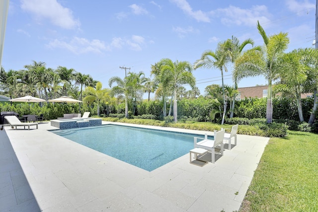 744 Eastwind Dr, North Palm Beach, FL 33408 - view of pool featuring a patio area, a pool with connected hot tub, and a yard