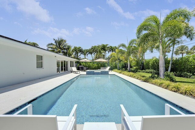 744 Eastwind Dr, North Palm Beach, FL 33408 - view of swimming pool with a pool with connected hot tub and a patio