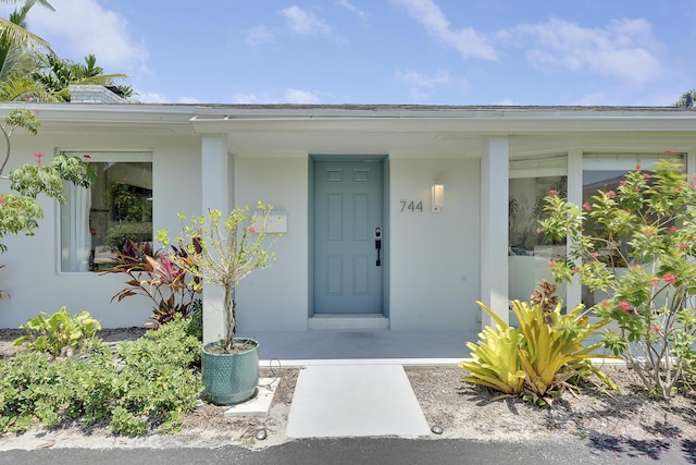 744 Eastwind Dr, North Palm Beach, FL 33408 - entrance to property featuring stucco siding