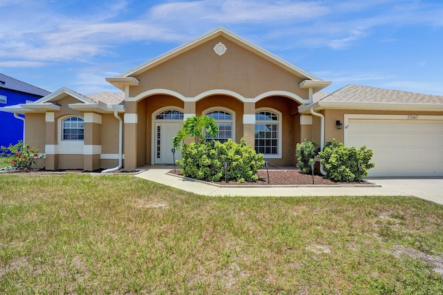 5940 NW Center St, Port Saint Lucie, FL 34986 - view of front of property featuring stucco siding, a front yard, a garage, and driveway