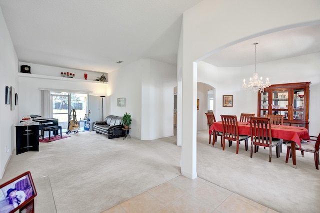 5940 NW Center St, Port Saint Lucie, FL 34986 - dining space with light carpet, arched walkways, a chandelier, and light tile patterned floors