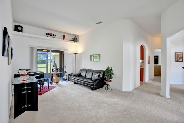 5940 NW Center St, Port Saint Lucie, FL 34986 - living area with light carpet, arched walkways, and baseboards