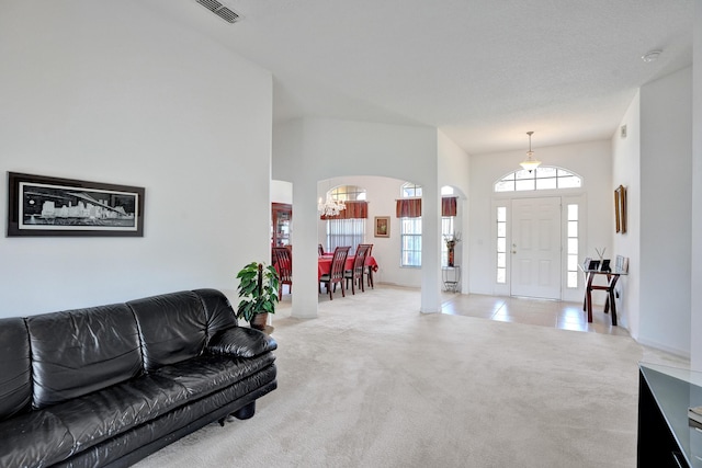 5940 NW Center St, Port Saint Lucie, FL 34986 - carpeted living room with arched walkways and a chandelier