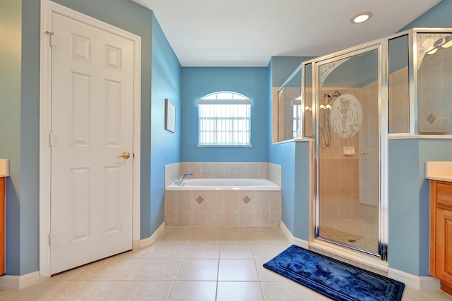 5940 NW Center St, Port Saint Lucie, FL 34986 - bathroom featuring vanity, a bath, a shower stall, tile patterned floors, and baseboards