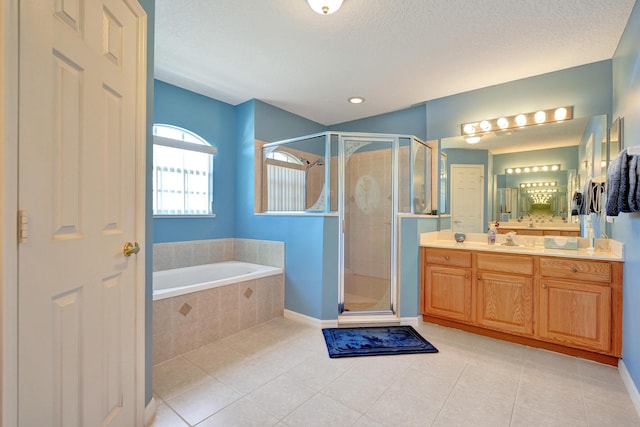 5940 NW Center St, Port Saint Lucie, FL 34986 - full bath with vanity, a stall shower, tile patterned floors, a garden tub, and a textured ceiling