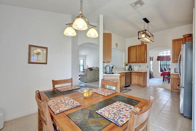 5940 NW Center St, Port Saint Lucie, FL 34986 - dining room with arched walkways, light tile patterned flooring, and baseboards