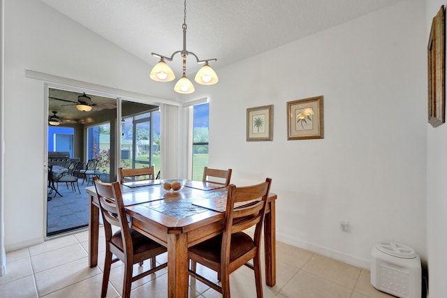 5940 NW Center St, Port Saint Lucie, FL 34986 - dining room featuring a chandelier, vaulted ceiling, baseboards, a textured ceiling, and light tile patterned floors