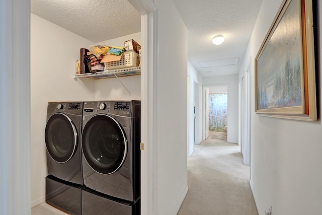 5940 NW Center St, Port Saint Lucie, FL 34986 - laundry area with washing machine and dryer, a textured ceiling, light carpet, attic access, and baseboards