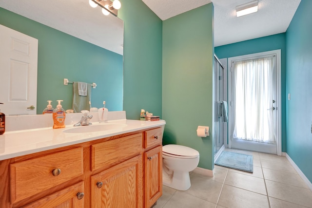 5940 NW Center St, Port Saint Lucie, FL 34986 - bathroom featuring toilet, a shower stall, vanity, baseboards, and tile patterned floors